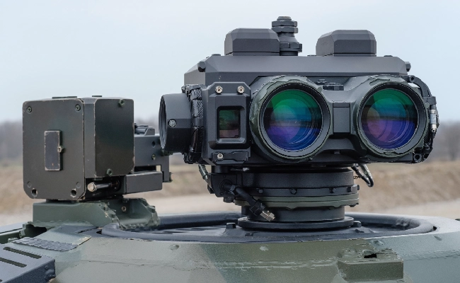 Dual-lens targeting sight mounted on the turret of an armored vehicle, used for aiming and range finding