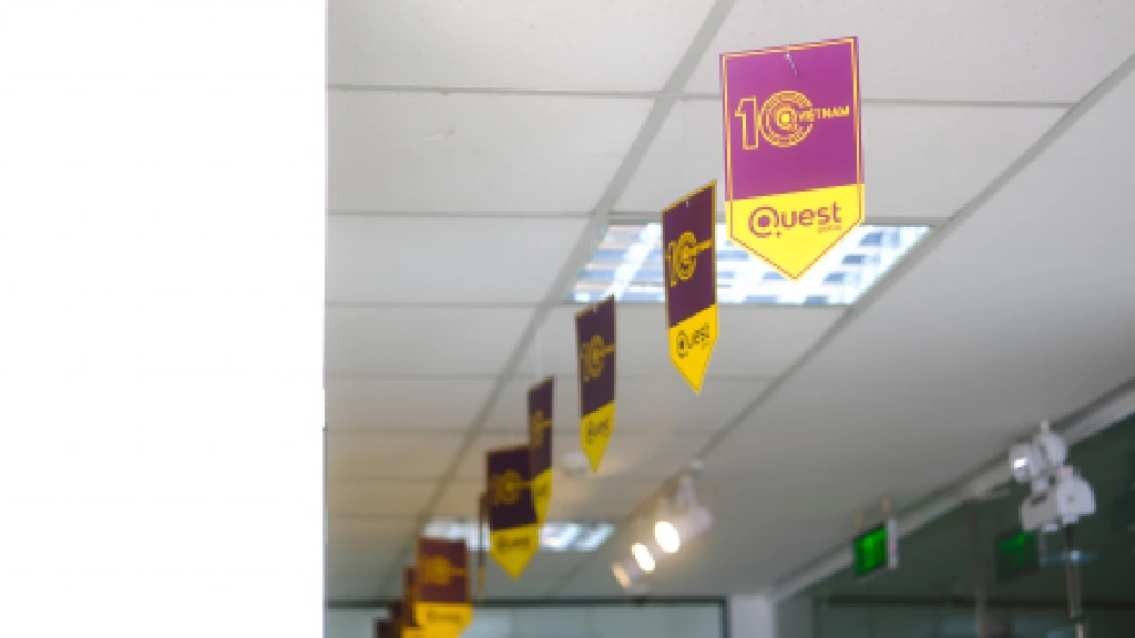 Branded ceiling decor celebrating a company milestone, 10 years of @Quest Vietnam