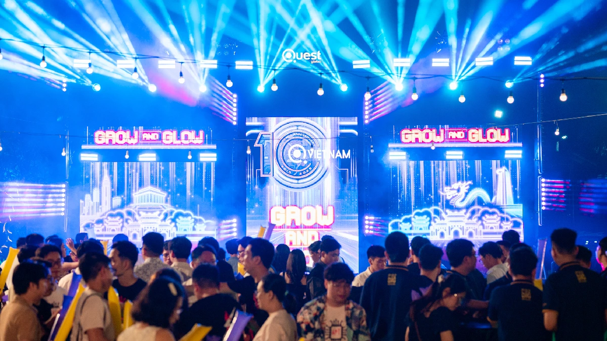 Audience watching presentation screens at Quest Global Vietnam event