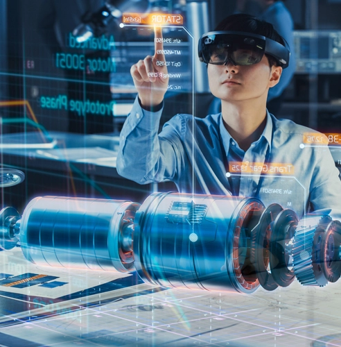 Researcher wearing an AR headset taps holographic screens above a blue cylindrical machine in a high-tech lab.