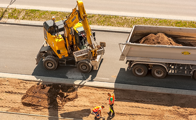 Excavator and dump truck at a construction site